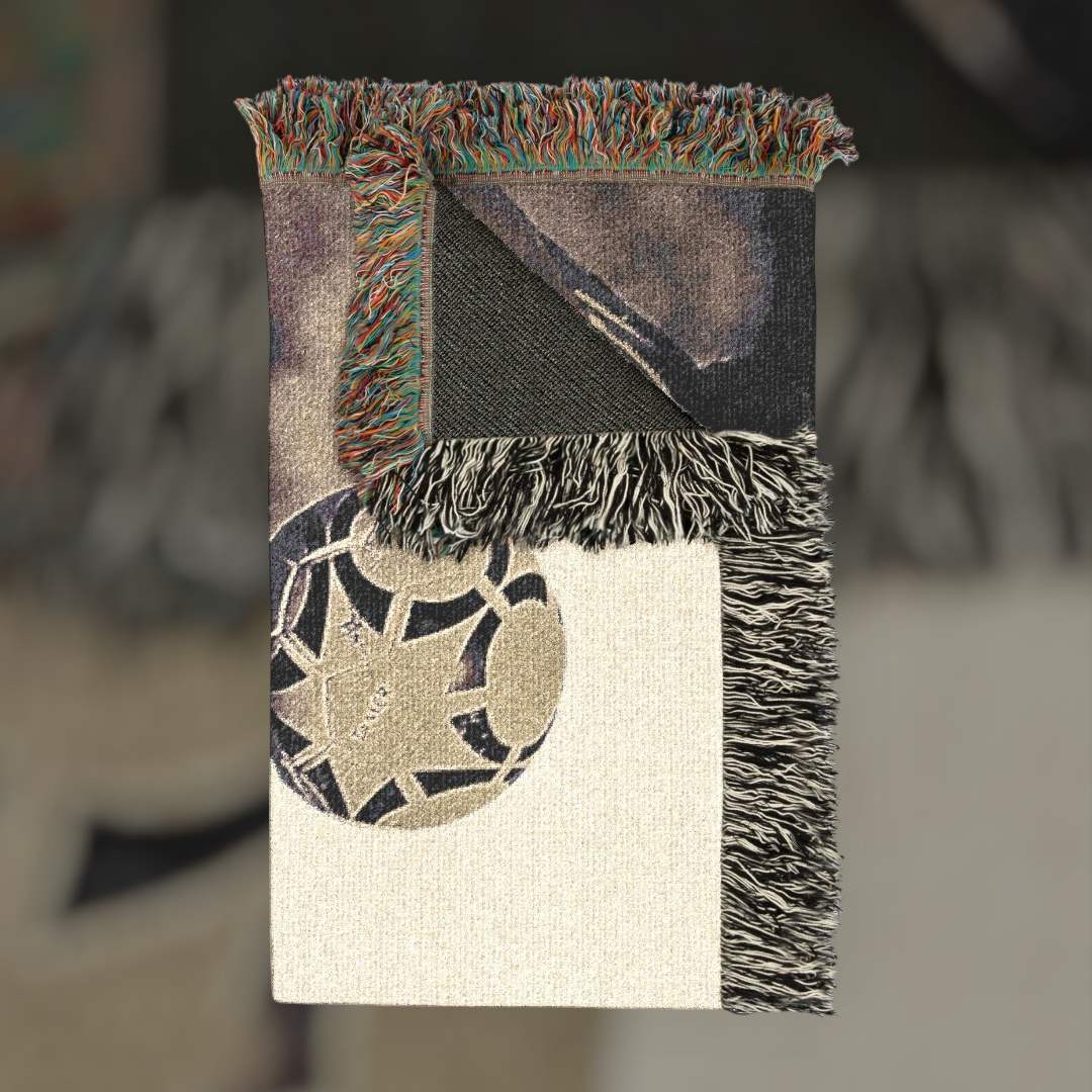 Futbol Addict Maradona Design woven cotton blanket with football graphic and colorful fringed edges.