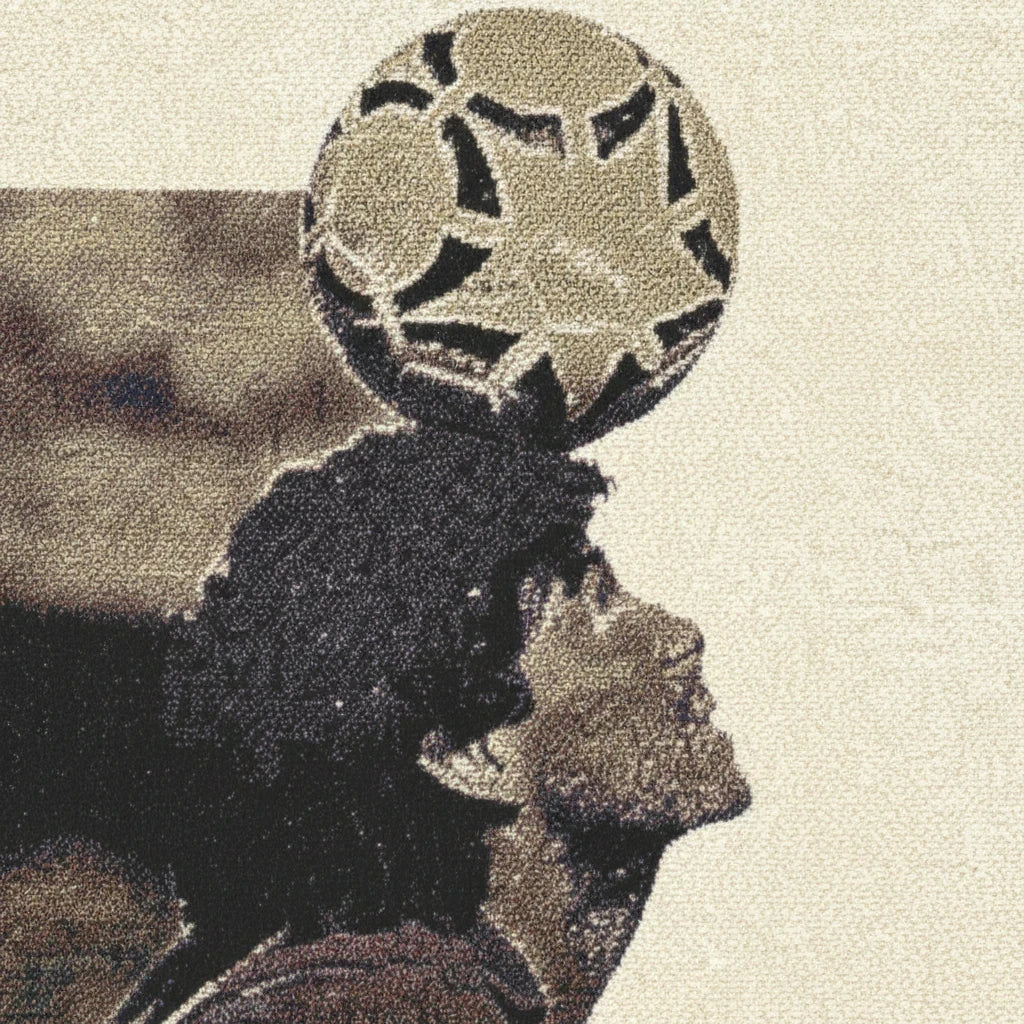 Futbol Addict Maradona woven cotton blanket featuring a detailed portrait of Diego Maradona balancing a soccer ball.