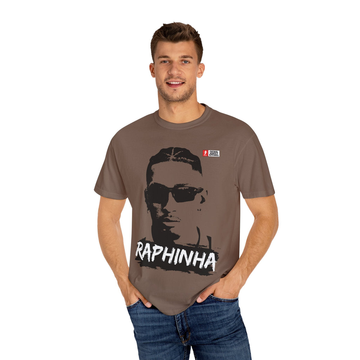 Futbol Addict brown oversized cotton graphic t-shirt featuring a portrait of Raphinha, worn by a smiling male model.