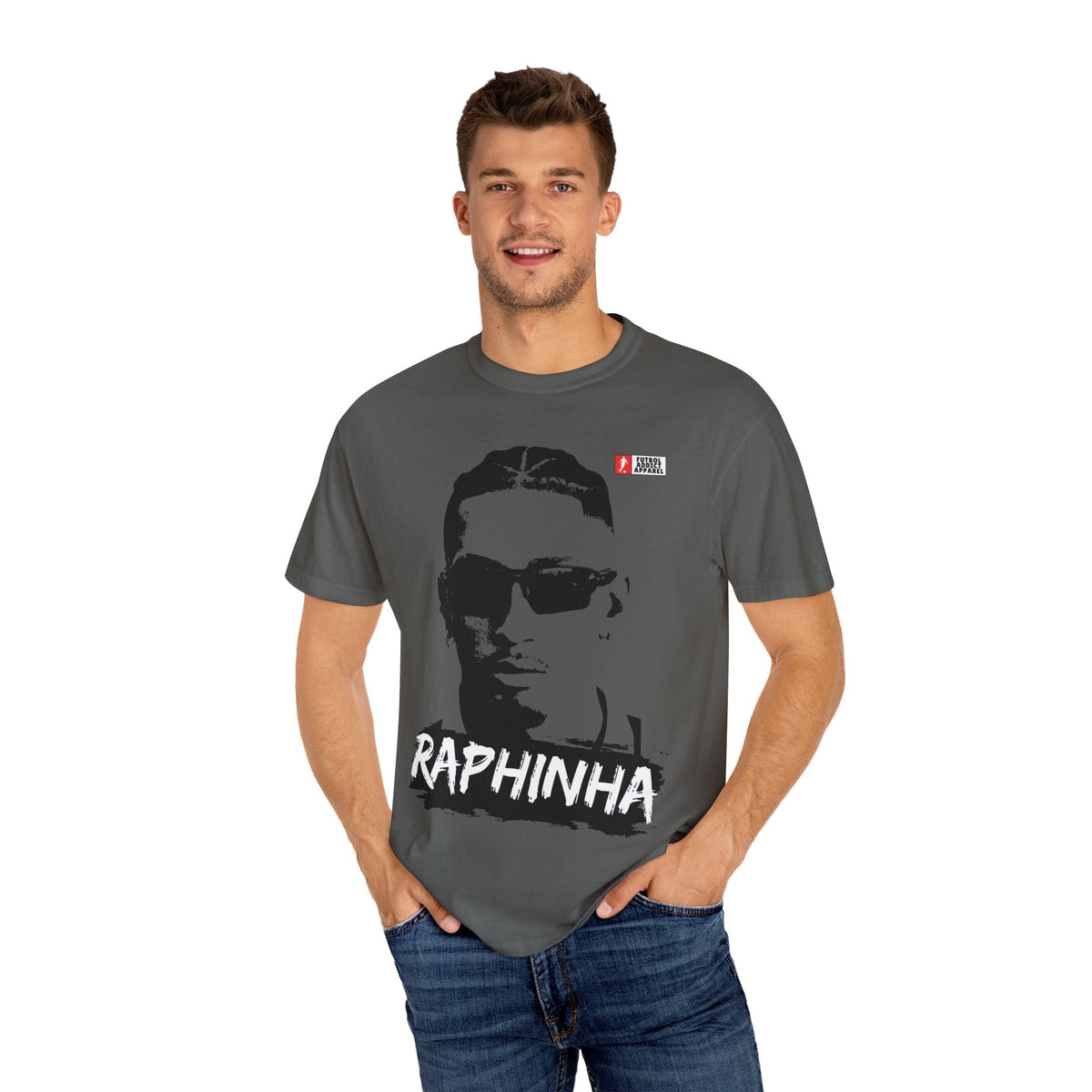 Futbol Addict oversized grey cotton graphic tee featuring a Raphinha portrait print worn by a smiling male model.