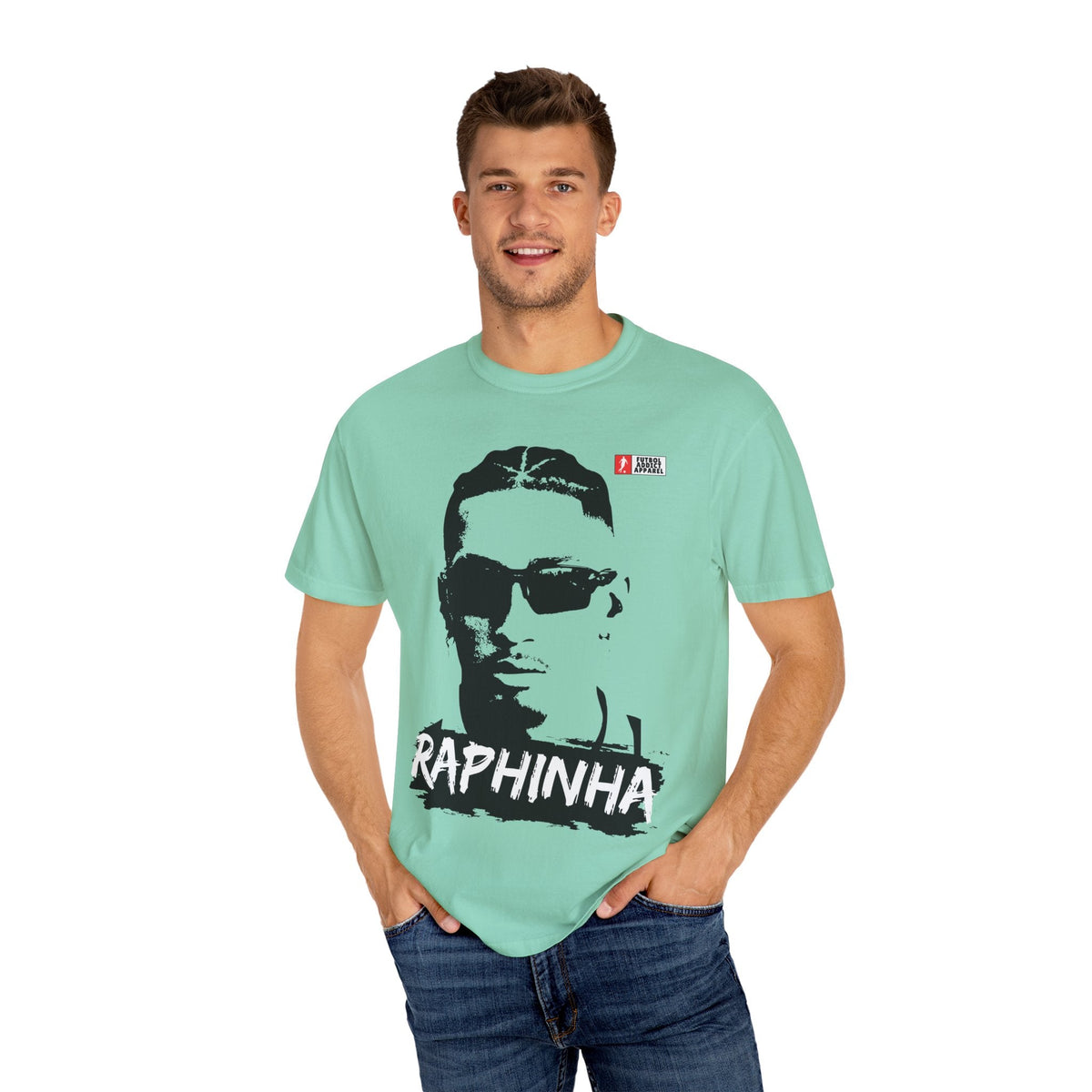Futbol Addict oversized mint green cotton graphic tee featuring a portrait of Raphinha, worn by a smiling male model.