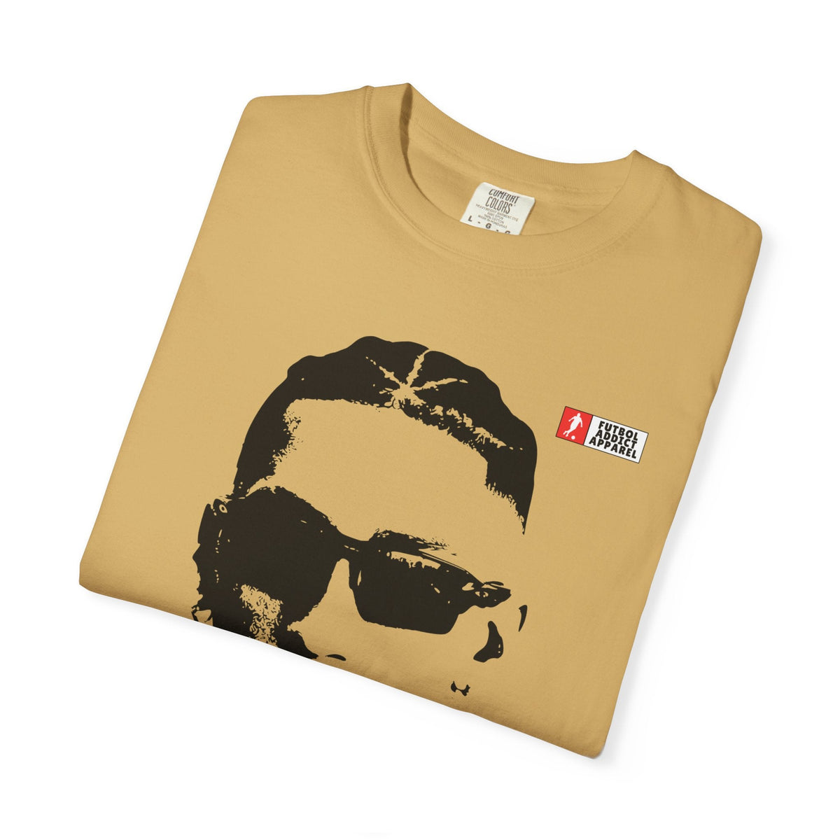 Futbol Addict Raphinha graphic tee in tan cotton with a vintage-style portrait print and small brand logo on chest.