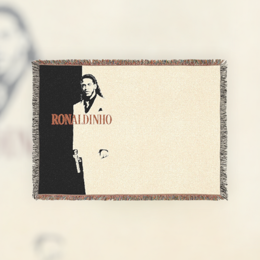 Futbol Addict Ronaldinho Scarface woven cotton blanket with colorful fringed edges and a black and white graphic design.