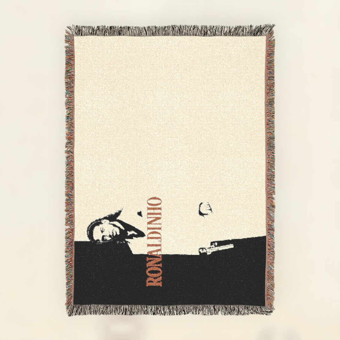 Futbol Addict Ronaldinho Scarface woven cotton blanket with a black and cream graphic and colorful fringed edges.
